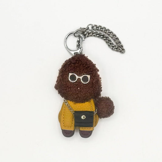 Charms Poodle marrone in tessuto teddy con occhiali da sole e mini borsa gialla