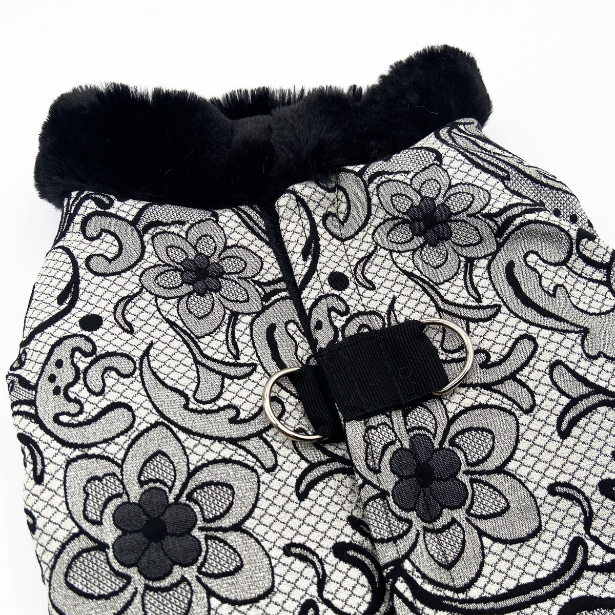 Dettaglio del jacquard con i fiori neri e dell'anello del Corpetto Astralis